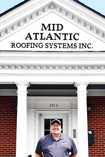 John Harrington Owner Of Mid Atlantic Roofing Standing In Front Of Office